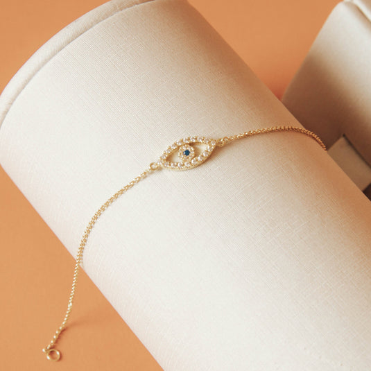 Pulseira Olho Grego Vazado com Safira e Pedras Brancas Sintéticas em Ouro 18k