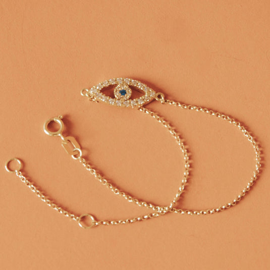 Pulseira Olho Grego Vazado com Safira e Pedras Brancas Sintéticas em Ouro 18k